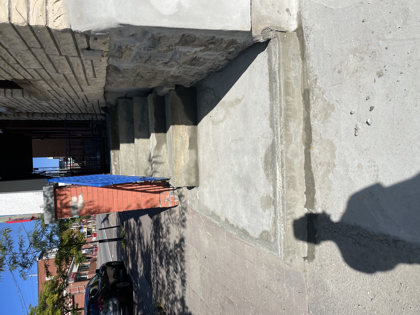 Finished concrete landing and step repair at a residential entrance