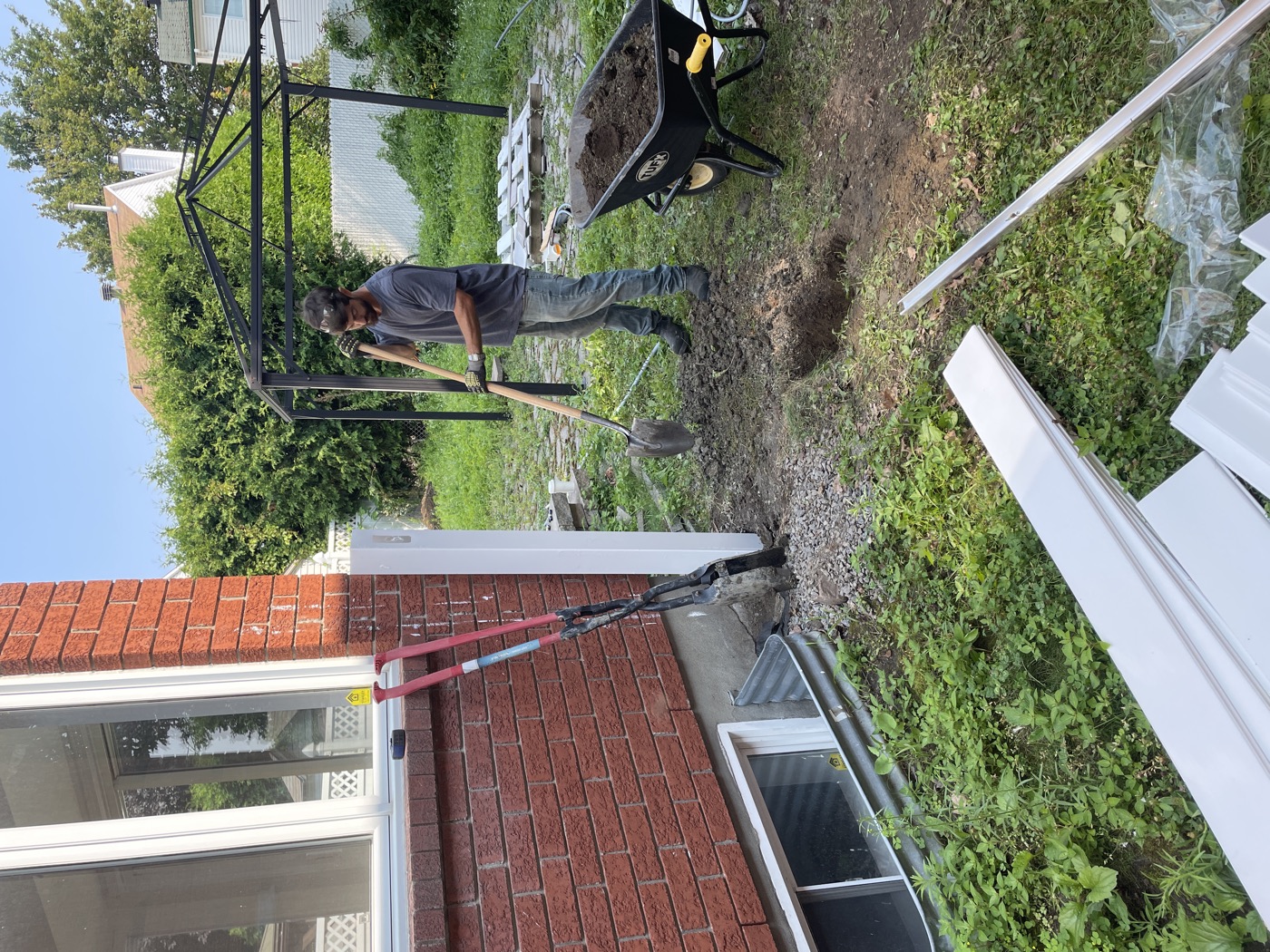 Contractor digging and preparing a residential outdoor work area